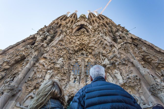 Barcelona: Sagrada Familia Guided Tour with Fast Track Access - The in-basilica experience: heavy doors, tree-like pillars, and meaning