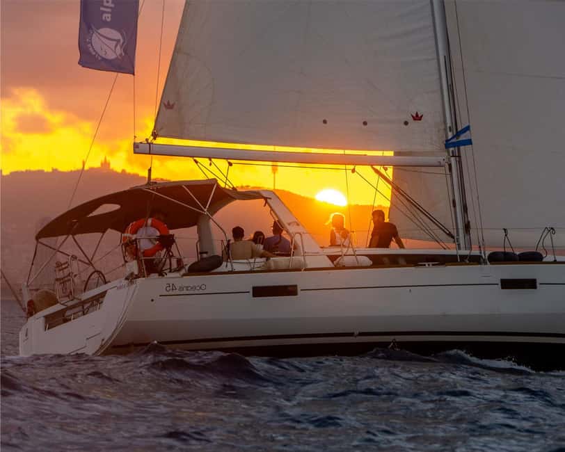 Barcelona: Sailing with Open Bar, Catalan Snack & Swim Stop - The secret stop swim: paddle boards, snorkeling gear, and snack time