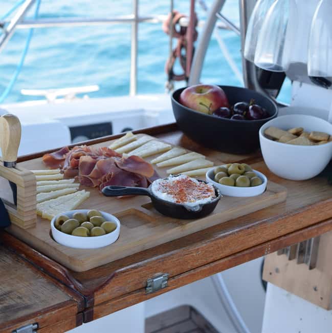 Barcelona: Sailing with Open Bar, Catalan Snack & Swim Stop - Captain matters more than you think: safety, stories, and sometimes hands-on sailing
