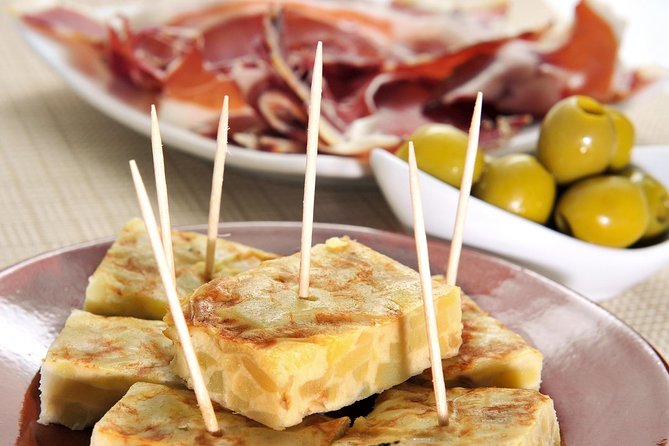 Tapas and Flamenco Show Small Group Tour in Barcelona - El Born ham store: jamón serrano and cheese tasting